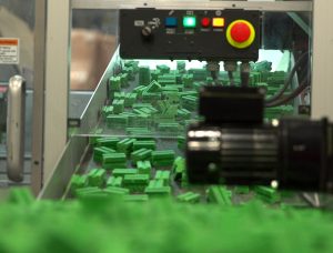 rodent bait coming down the shoot of a manufacturing machine